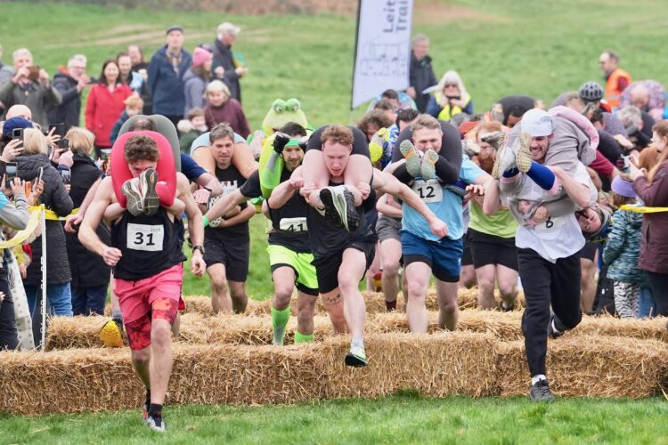 Finnish pair wins a barrel of ale in annual ‘wife-carrying’ contest in England